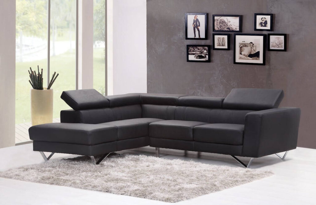 A black fabric sectional next to a glass window