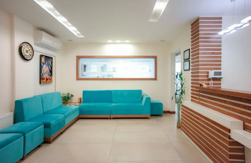 A waiting room with blue couches.